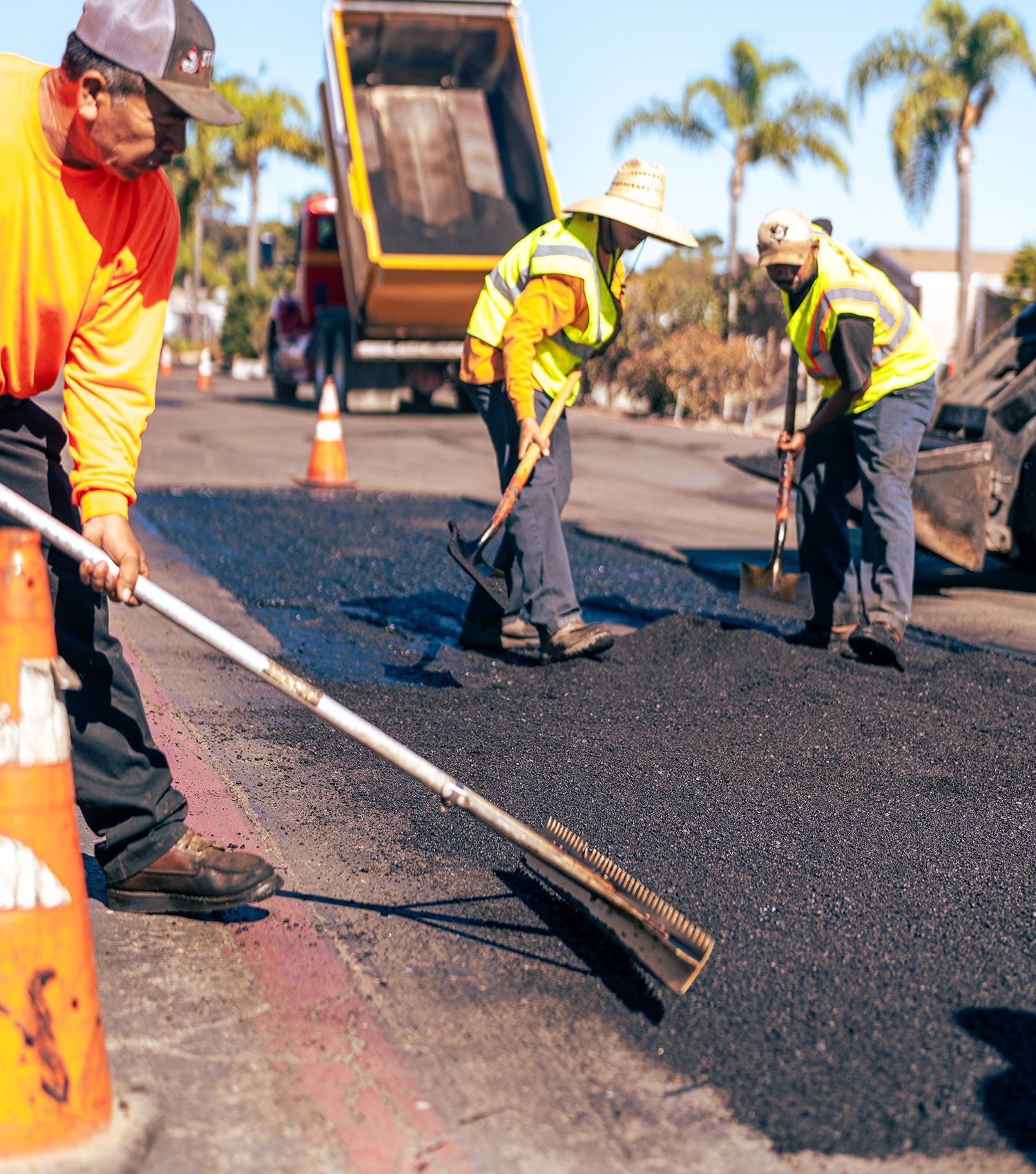 A group of construction workers are working on a road