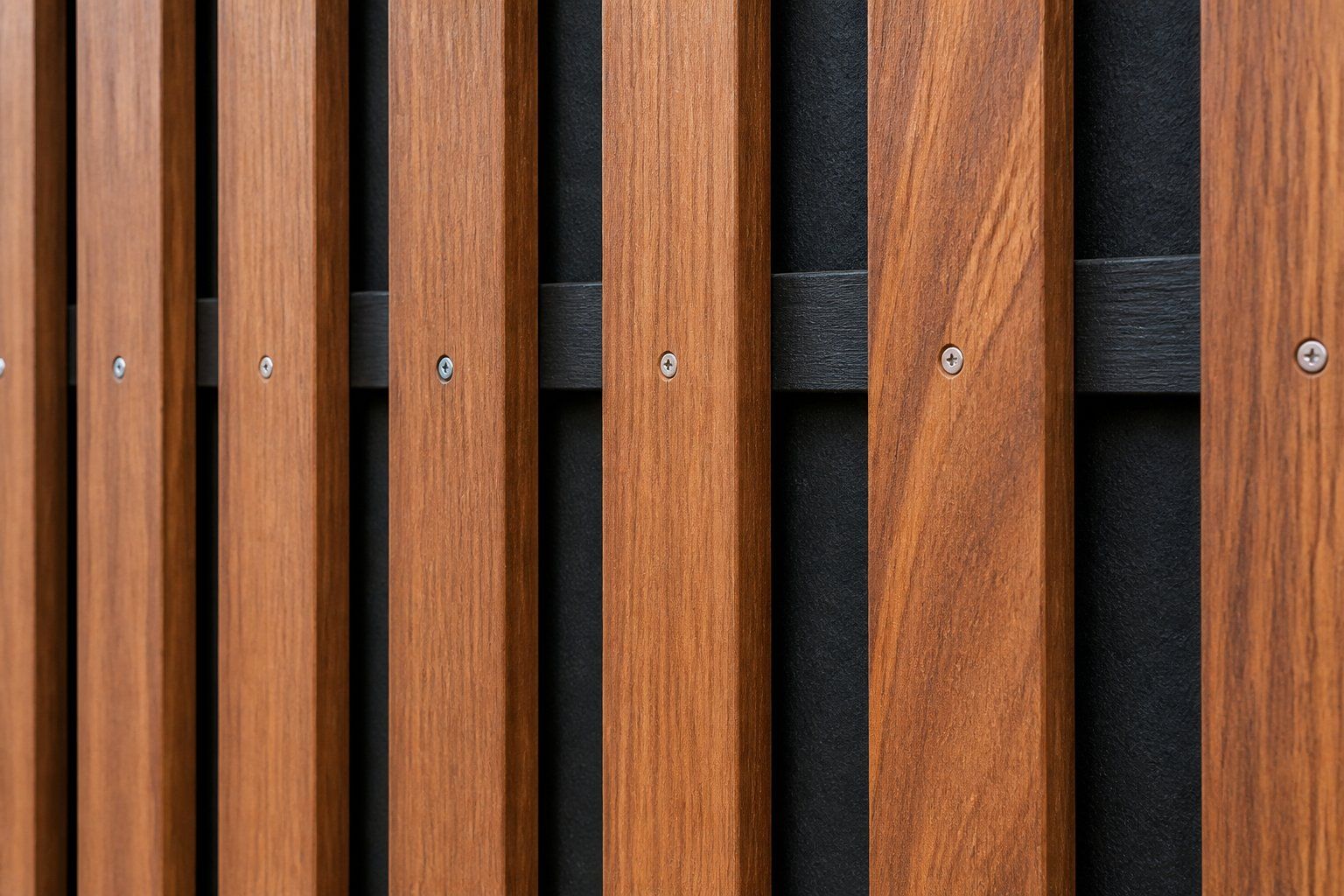 Close-up of vertical wooden slats with visible screws against a dark background