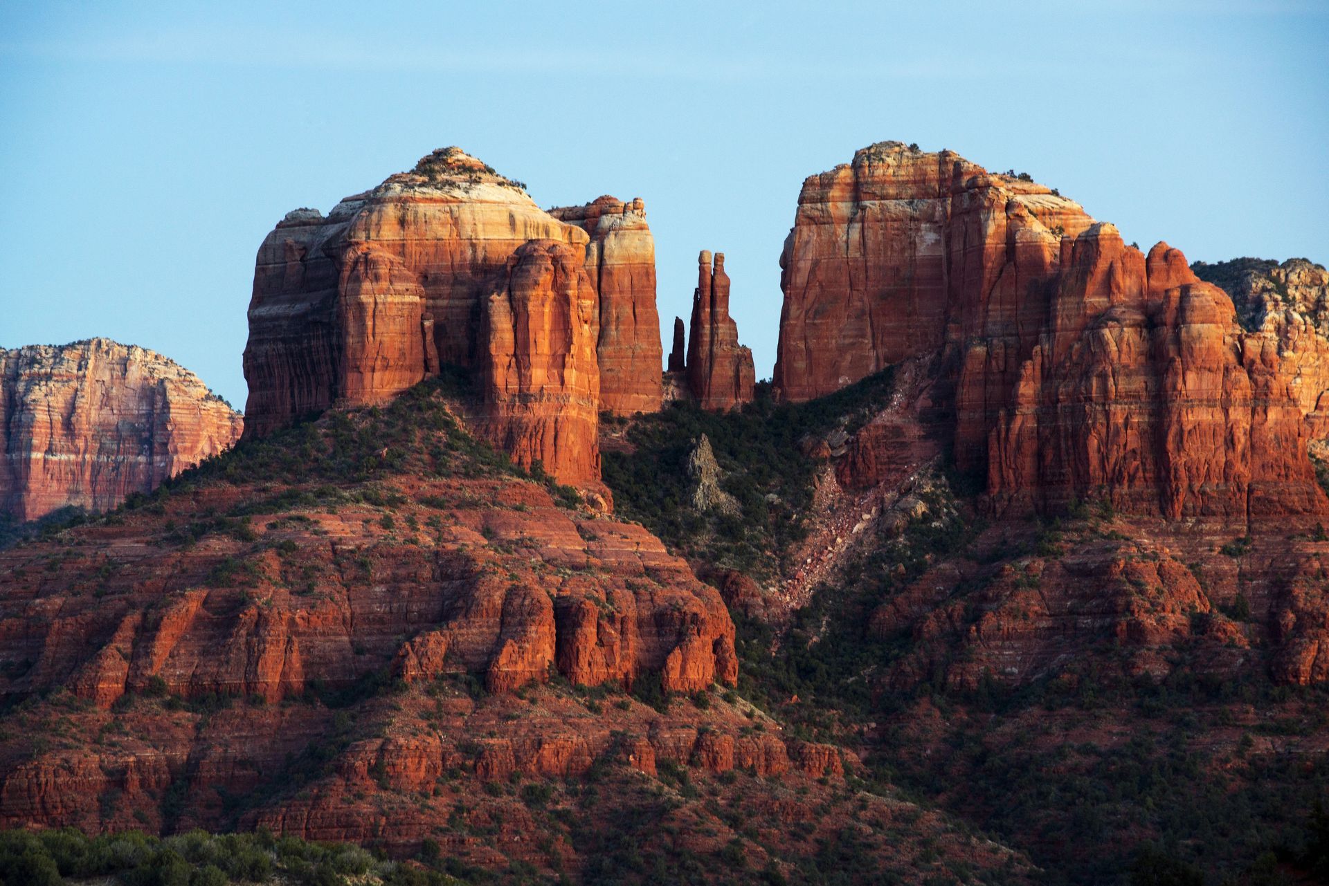 A large rock formation in the middle of a desert.
