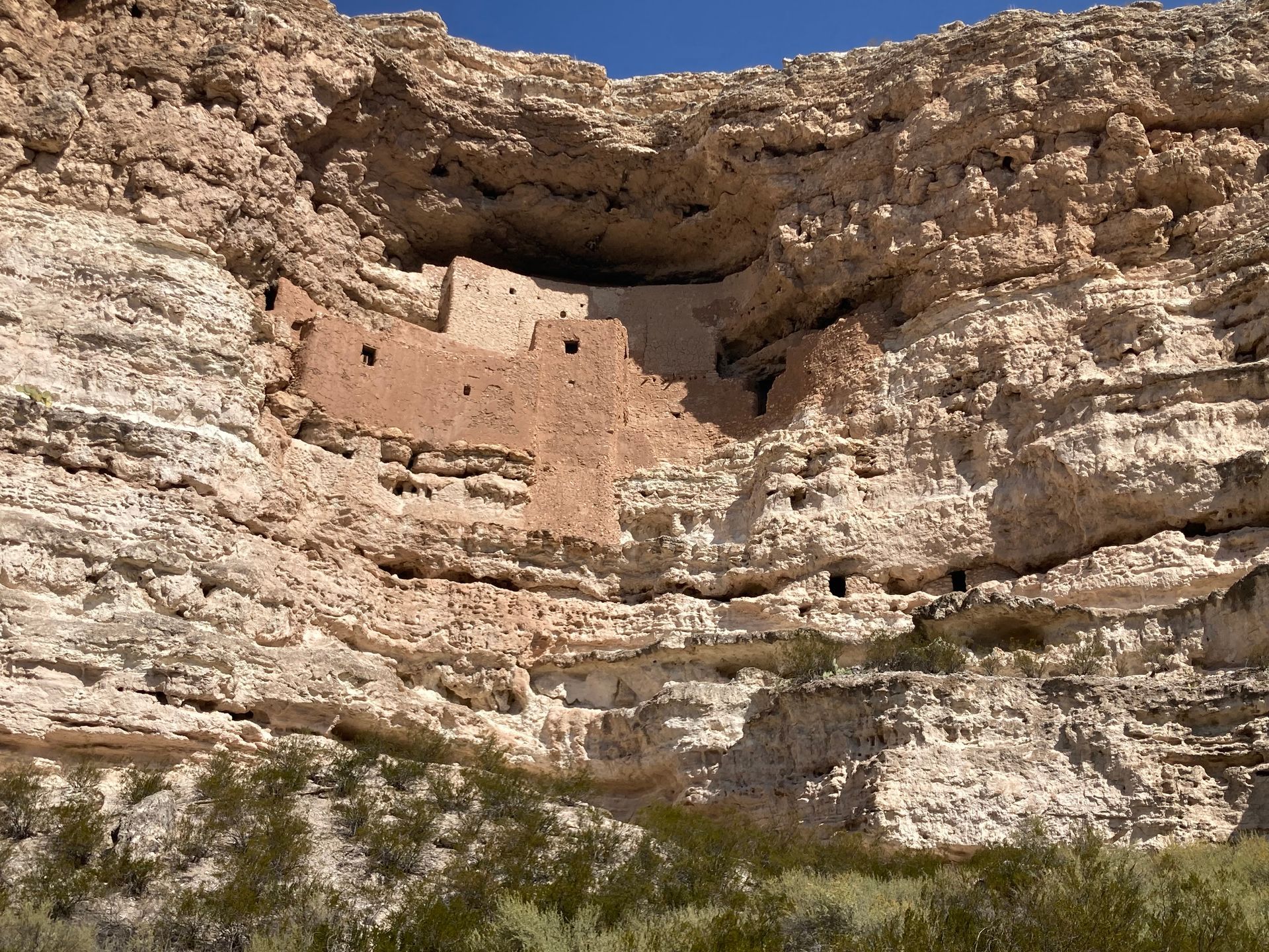 A cliff with a building in the middle of it