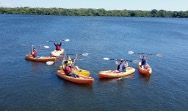 A group of people are kayaking on a lake.