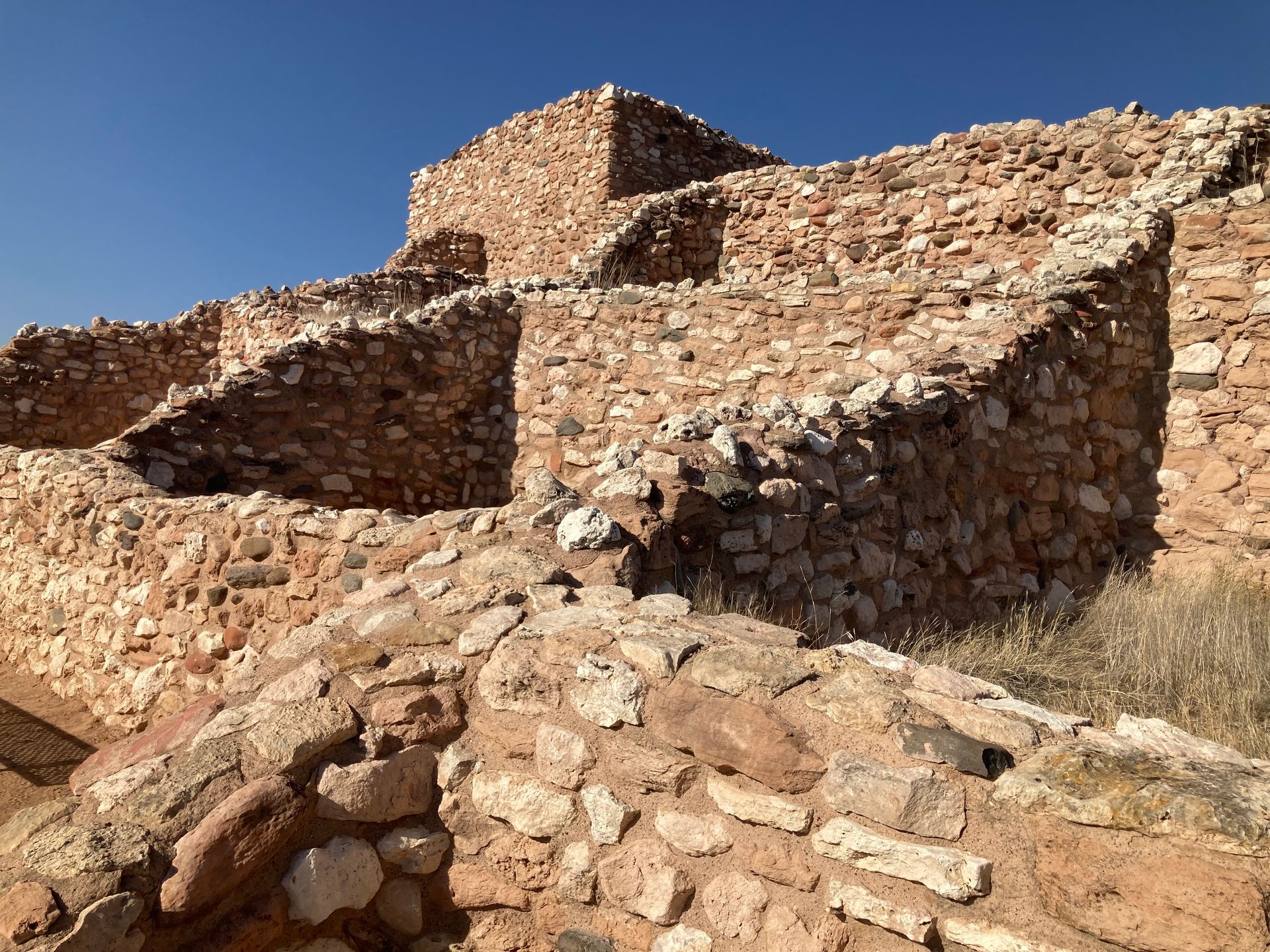 A stone wall with a blue sky in the background
