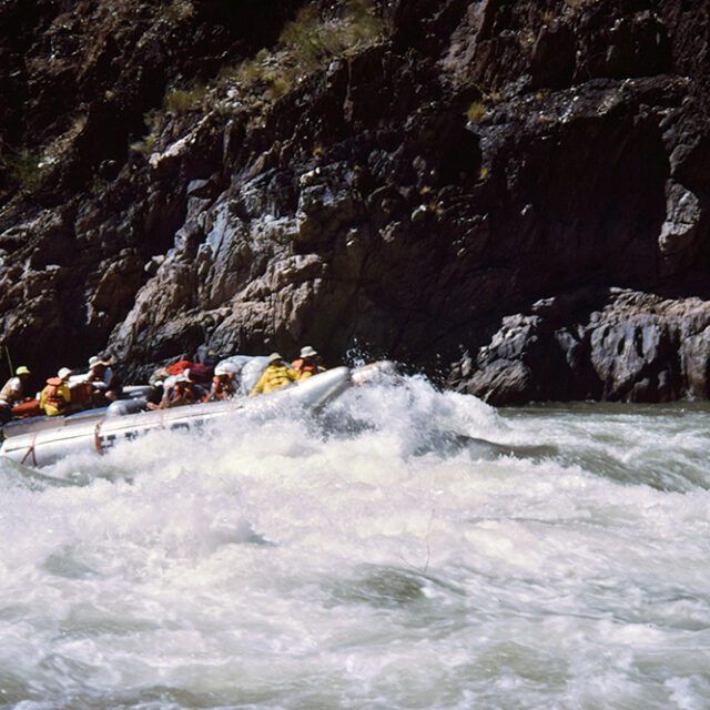 A group of people are rafting down a river