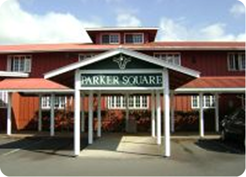 Entrance to Parker Square shopping center with red buildings and white columns