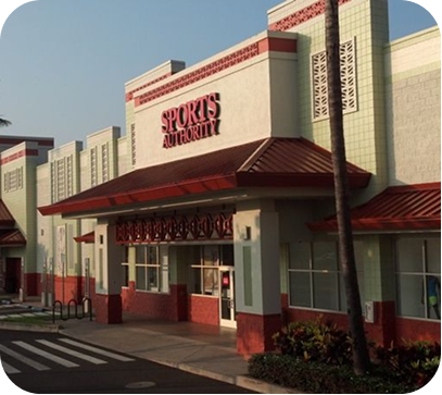 Sports Authority storefront with red awnings and beige facade in a shopping plaza.