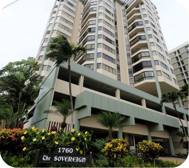 High-rise apartment building with balconies and landscaped entrance sign reading 1760 C.N. Sovereign
