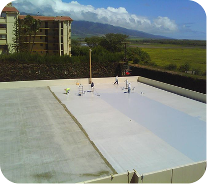 Rooftop under construction with white waterproofing, workers, apartment building, and mountains in the distance