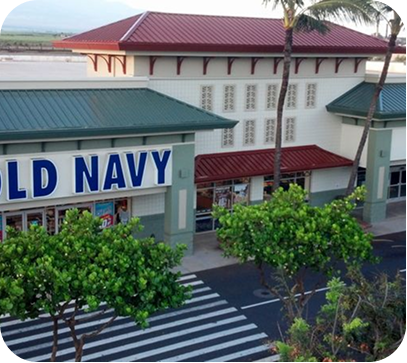 Old Navy storefront in a shopping center with a red roof and green trees in front