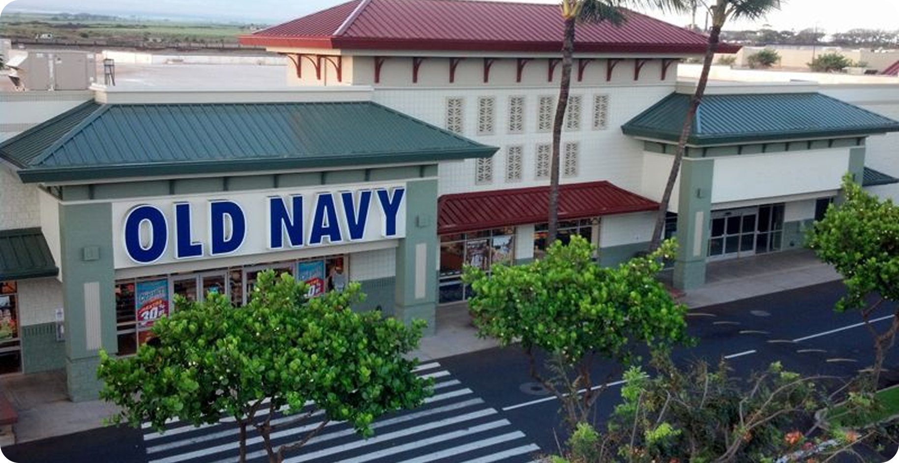 Old Navy storefront with blue roof and large sign at a shopping plaza