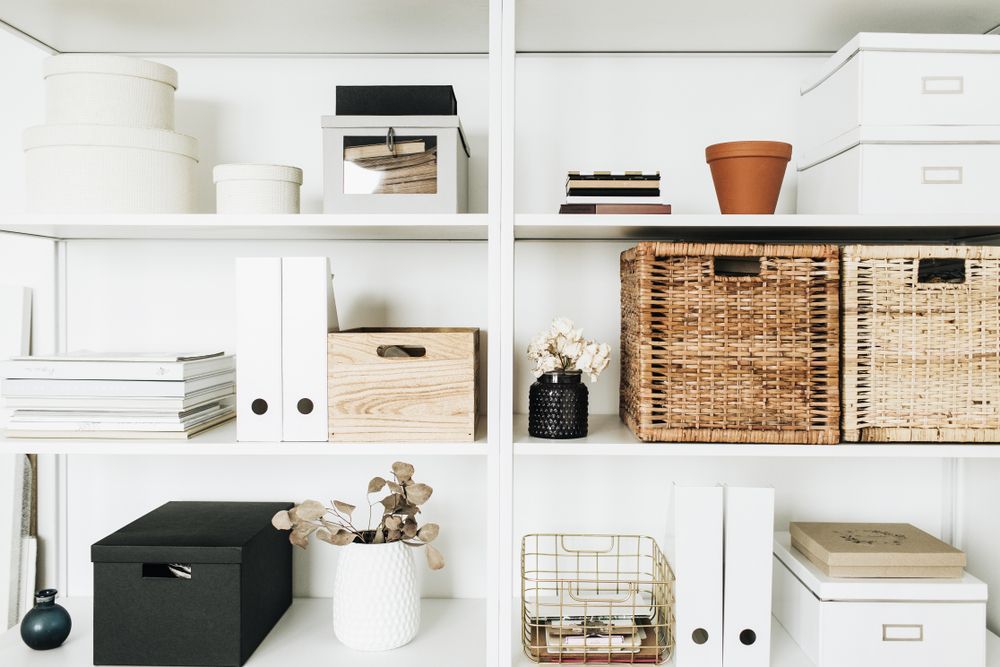 A White Shelf Filled With Lots Of Boxes And Baskets — Harris Design & Building Concepts In Whitsunday Region, QLD