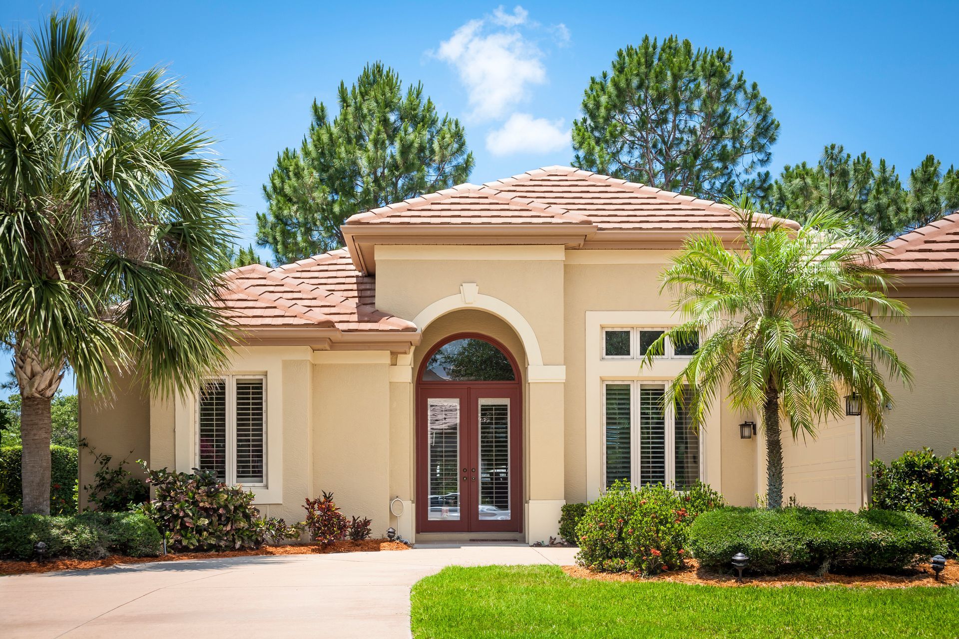 A large white house with a driveway leading to it.