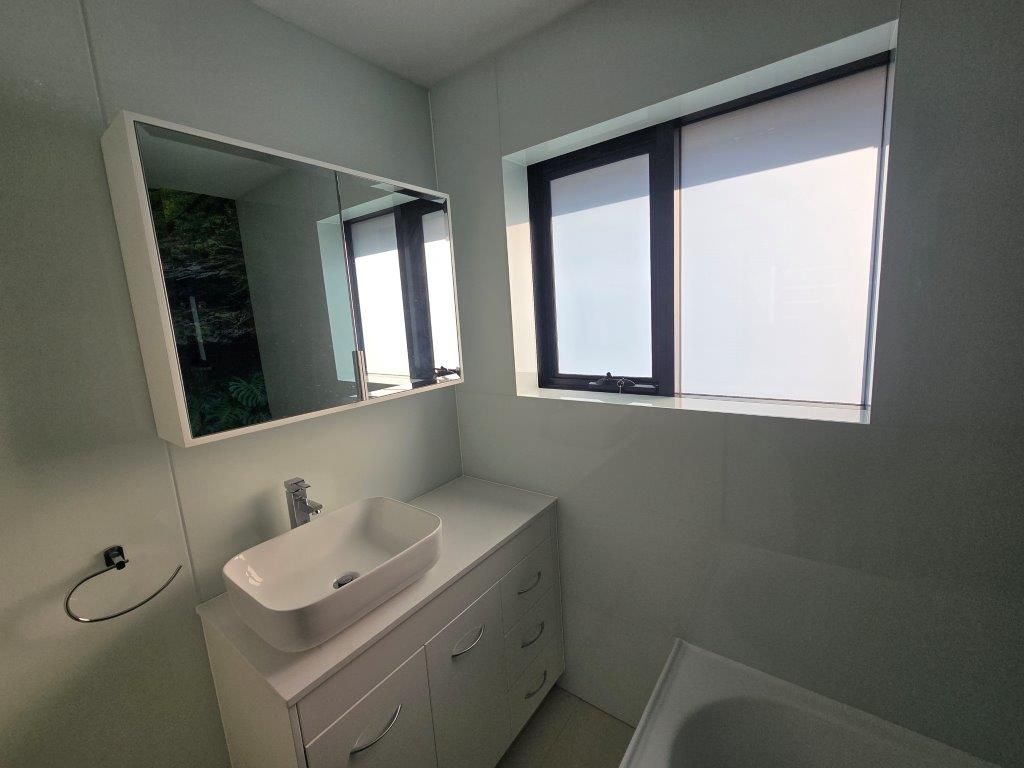 A bathroom with two sinks and a mirror.
