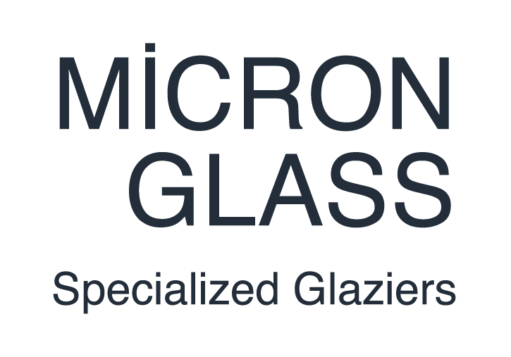 A logo for a company called micron glass specialized glaziers.