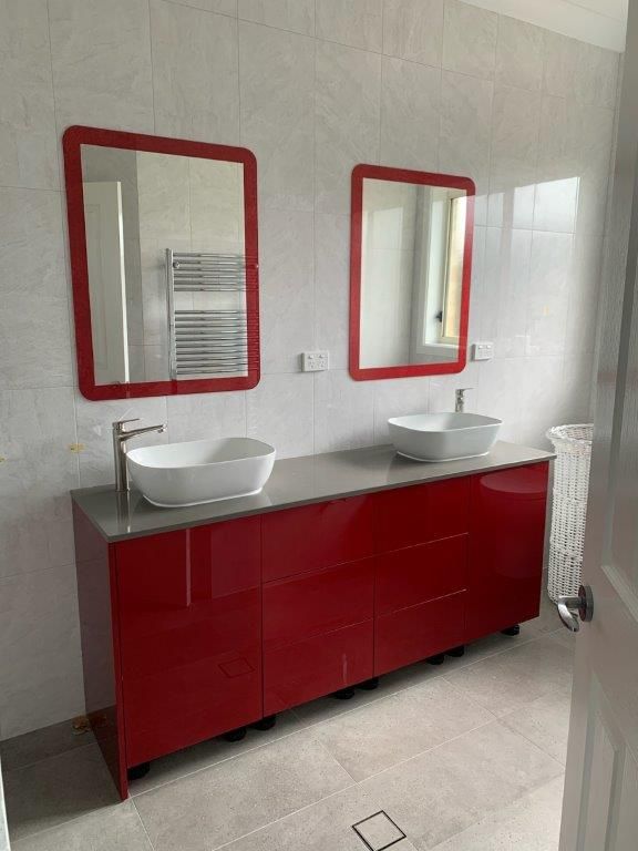 A bathroom with two sinks and two mirrors