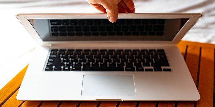 Hand Closing the White Laptop — University Place, WA — ComputerLab
