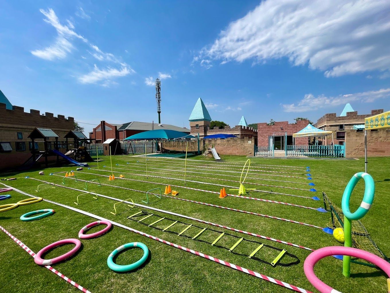A large grassy field with a lot of toys on it.