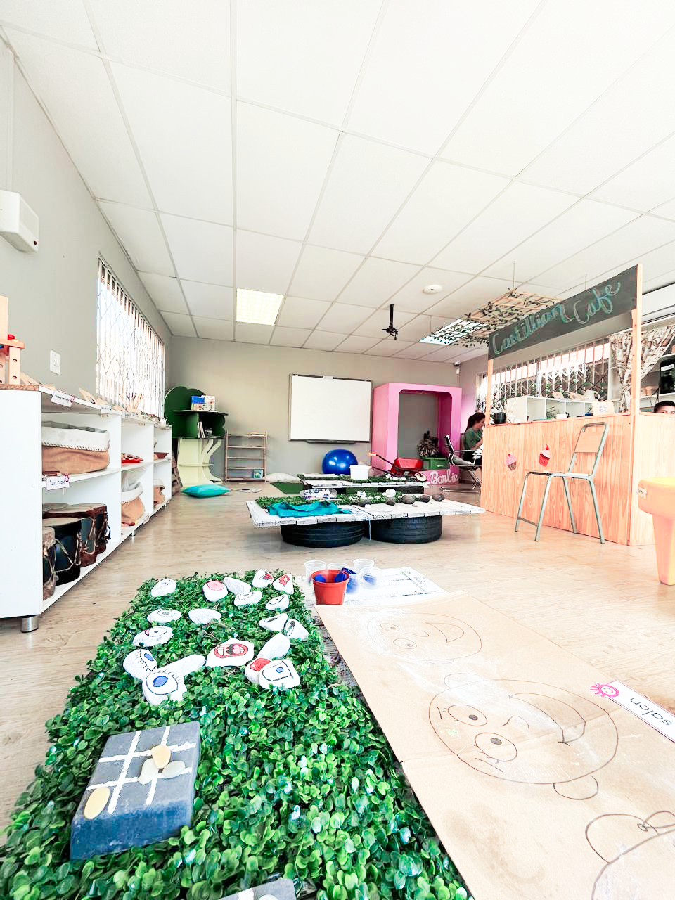 A large room with a lot of toys on the floor.