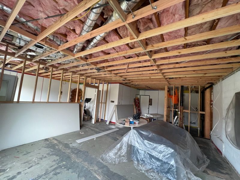 A room under construction with a lot of wooden beams and insulation.