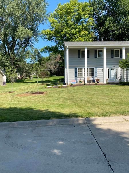 A large white house with a large lawn in front of it