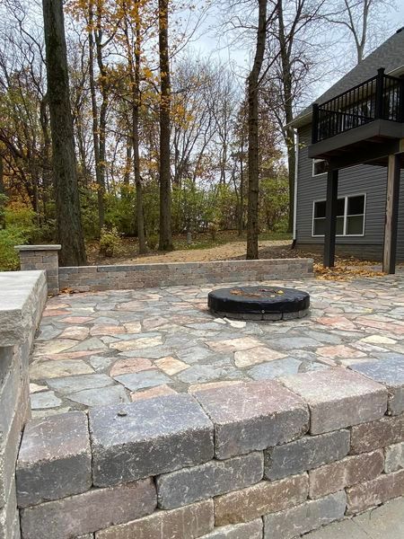 There is a fire pit in the middle of the patio.