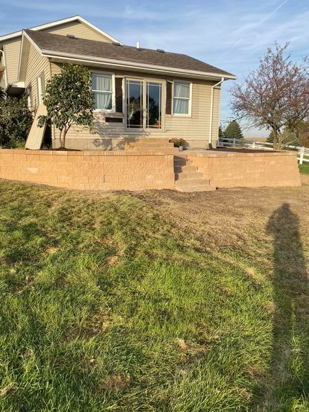 A house with a brick wall in front of it