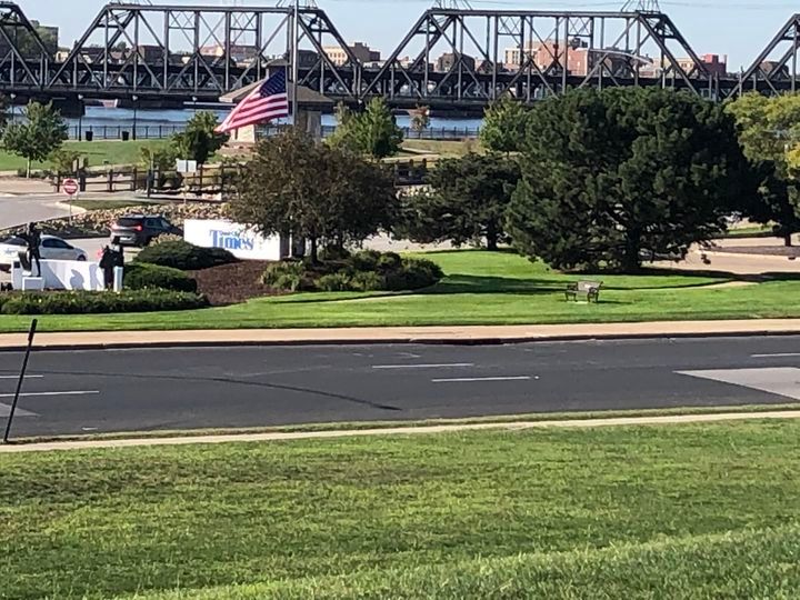 A bridge over a river with an american flag in the foreground