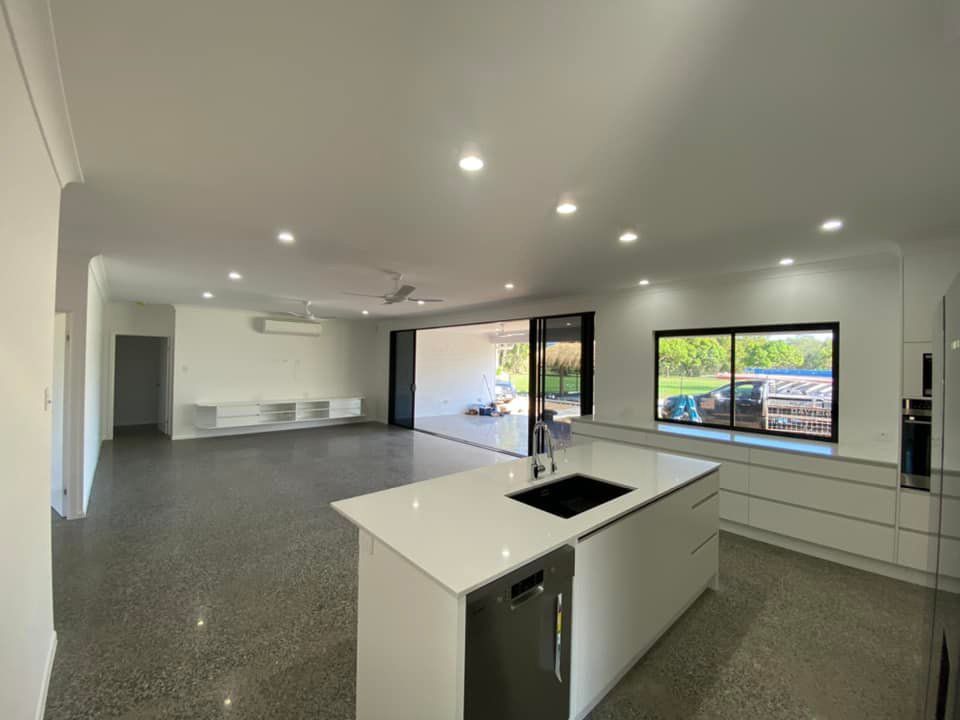 A Kitchen With A Large Island In The Living Room With New Install Lightings — DAV Electrical in Kirwan QLD