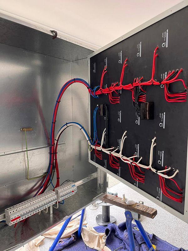 A Bunch Of Wires Are Hanging On A Wall In A Room — DAV Electrical in Kirwan QLD