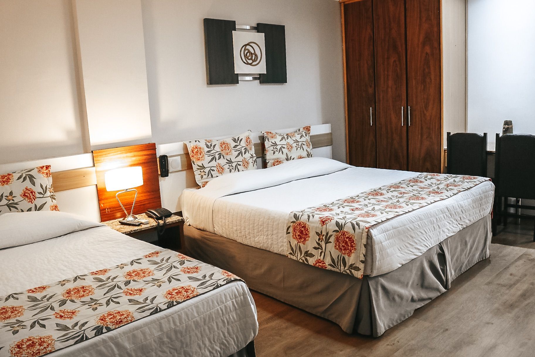 Um quarto de hotel com duas camas e uma mesa