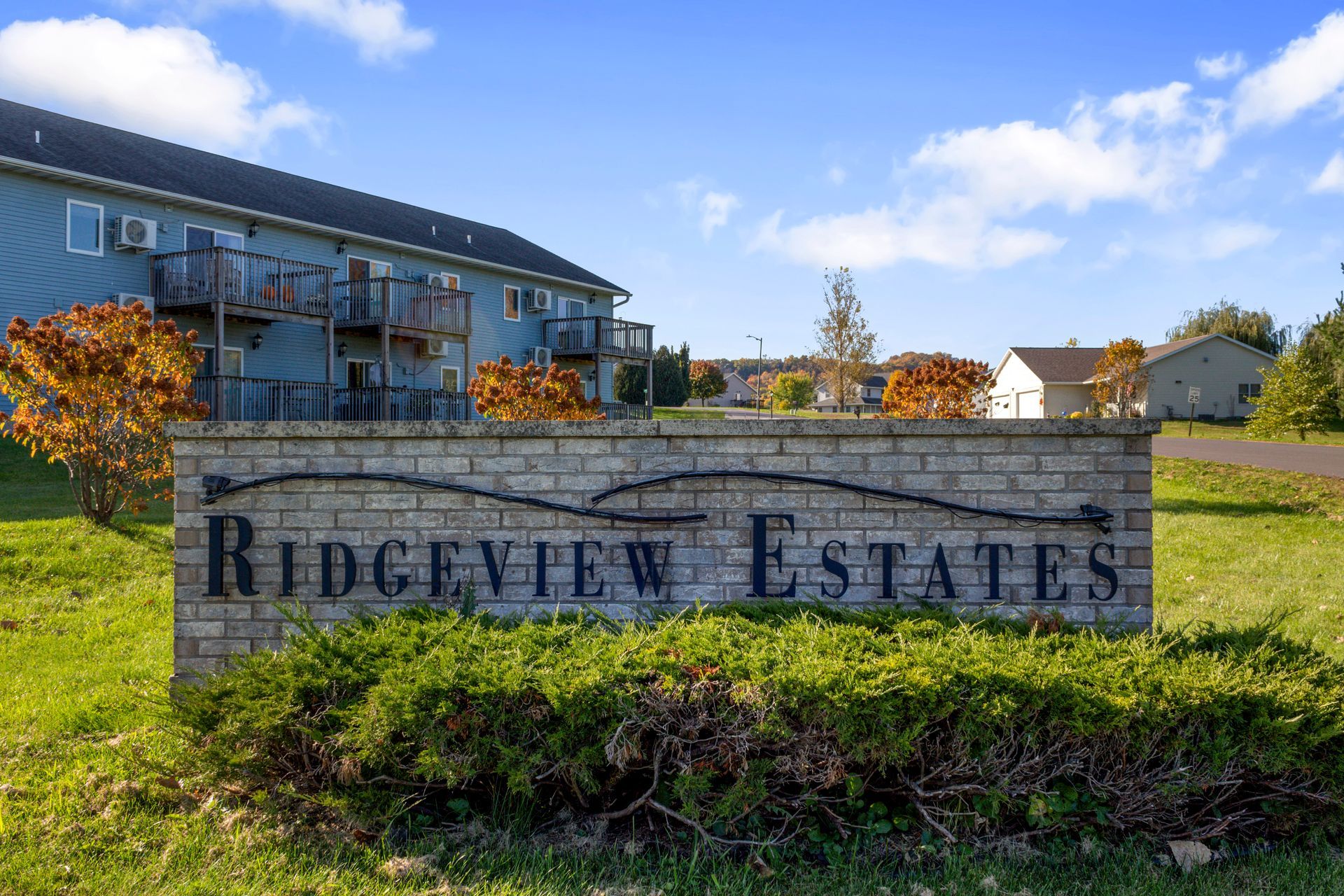 A sign for ridgeview estates is in front of a building.