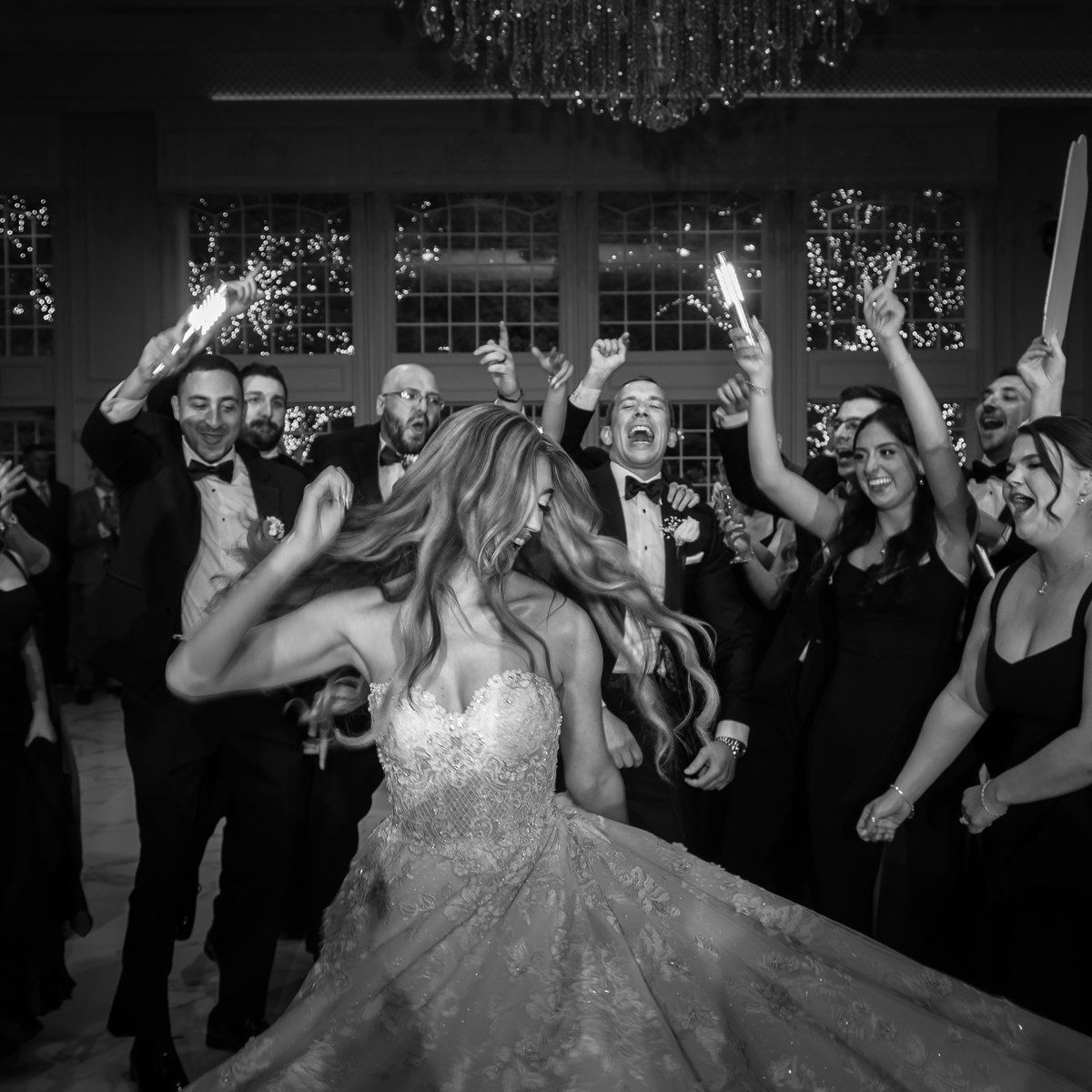 Bride spinning on the dance floor surrounded by the wedding party at Florentine Gardens