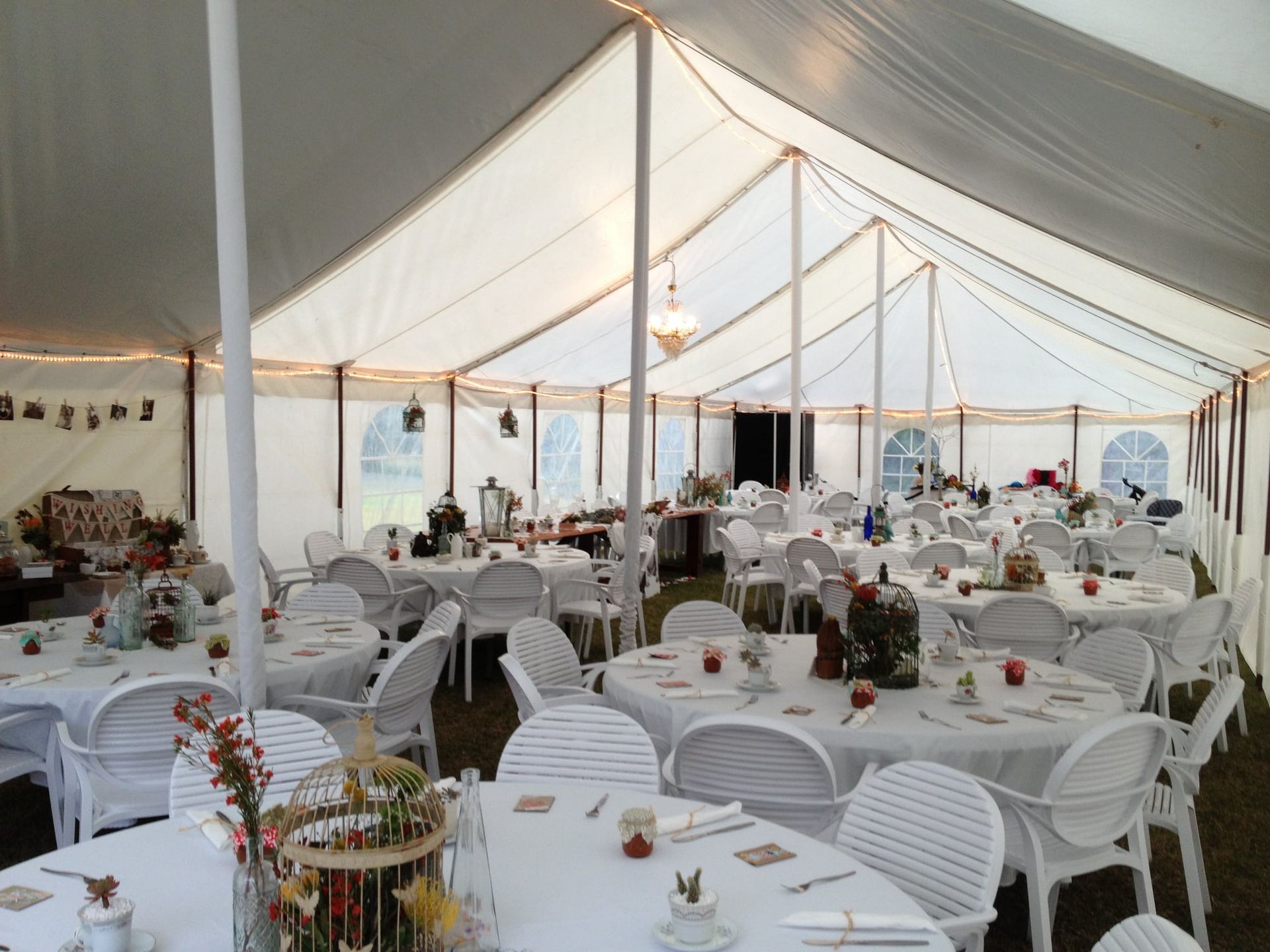 A Large White Tent With Tables And Chairs Underneath It – Caboolture, QLD - R & R Hire Services