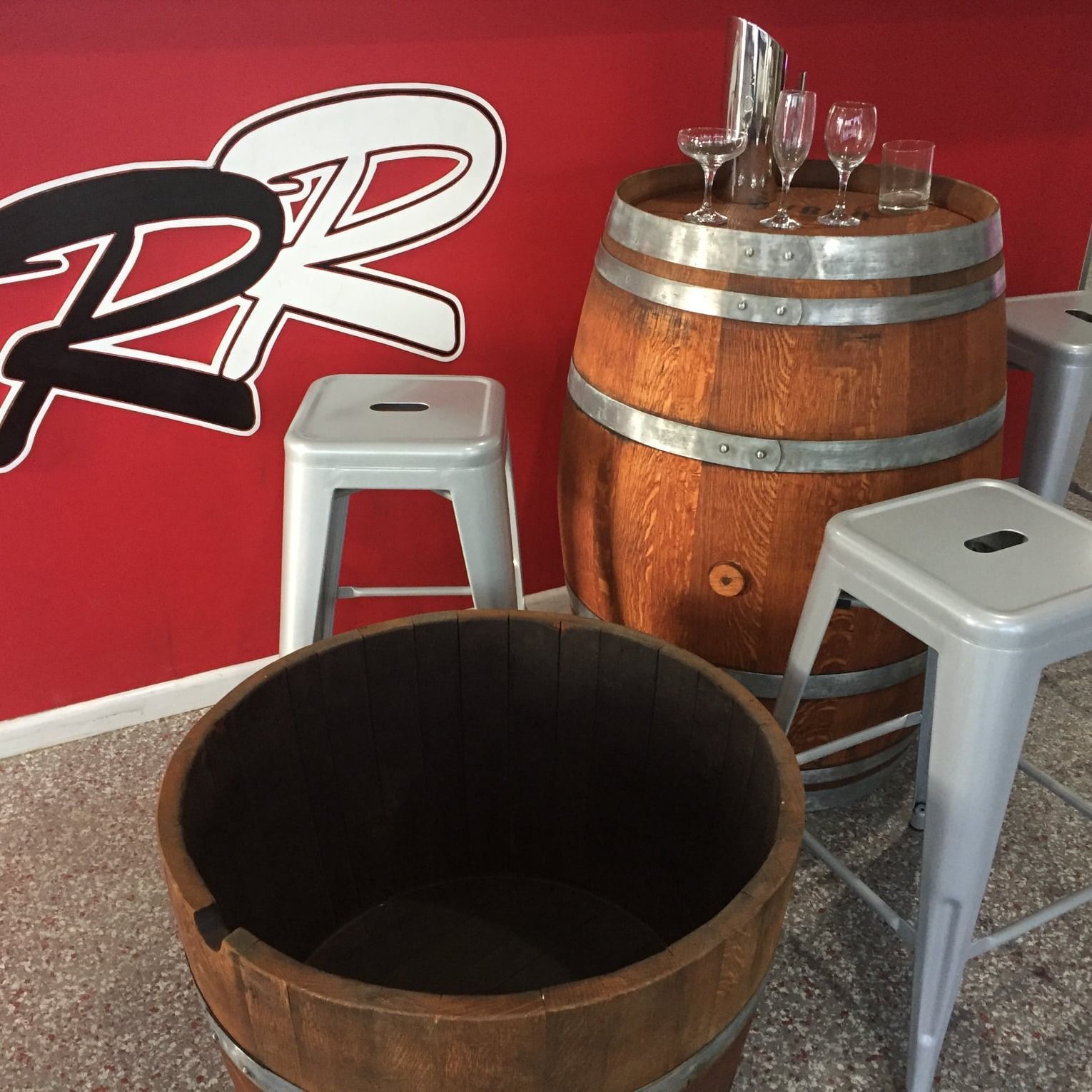 A Wooden Barrel Sits In Front Of A Red Wall With The Letter R On It – Caboolture, QLD - R & R Hire Services