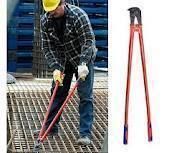 Construction worker using red bolt cutters to cut metal on a steel grate.