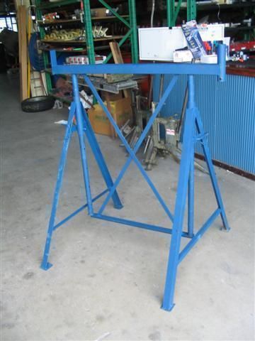 Blue metal work stand in a warehouse setting.