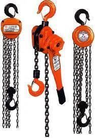 Three orange chain hoists with black chains and hooks.
