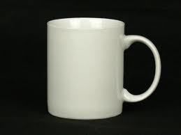 White ceramic mug with a curved handle, set against a black background.