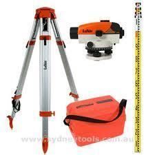 Surveying equipment: tripod, level, measuring rod, and orange carrying case.