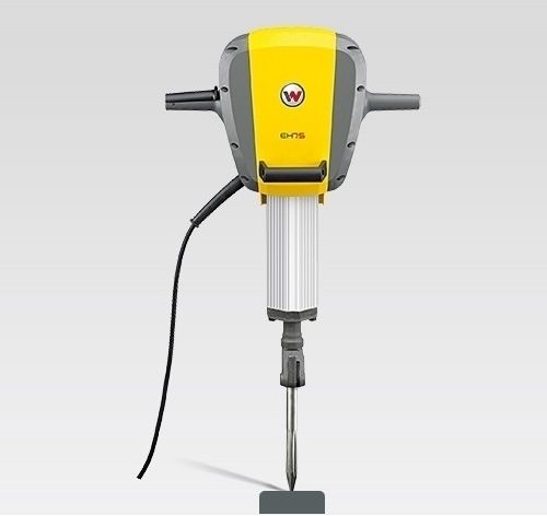 Yellow and gray electric demolition hammer, with a black cord, on a gray background.