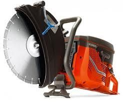 Orange and black Husqvarna K360 power cutter with a large circular blade.