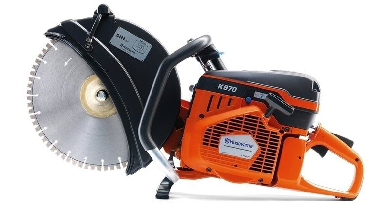 Orange Husqvarna K970 concrete saw with a silver blade, black guard, and handle.