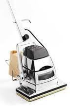 Shiny upright vacuum cleaner with a beige dust bag, on a white background.