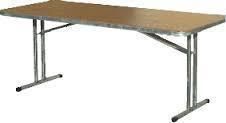 Rectangular tan folding table with metal legs, set on a white surface.