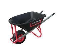 Black wheelbarrow with red frame, filled with nothing, on a white background.