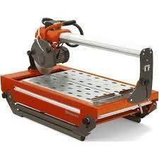 Orange and black tile saw with a circular blade, used for cutting tiles.