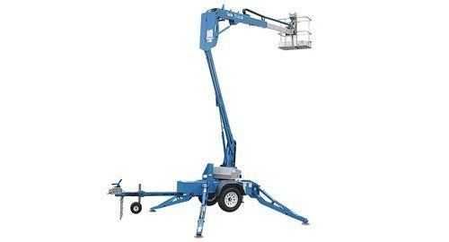 Blue articulating boom lift with outriggers, supporting a person in a bucket.