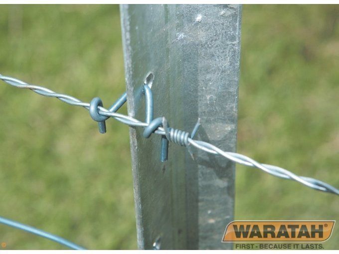 Barbed wire fence attached to a metal post, with a Waratah logo in the bottom right corner.