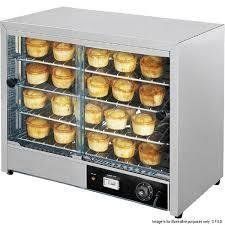 Commercial pie warmer with multiple shelves of pies behind glass.