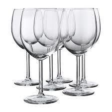Six clear wine glasses, arranged in a row, on a white background.