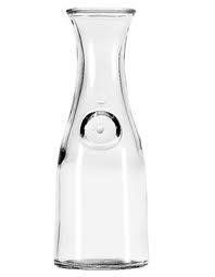 Clear glass carafe with a round indent.